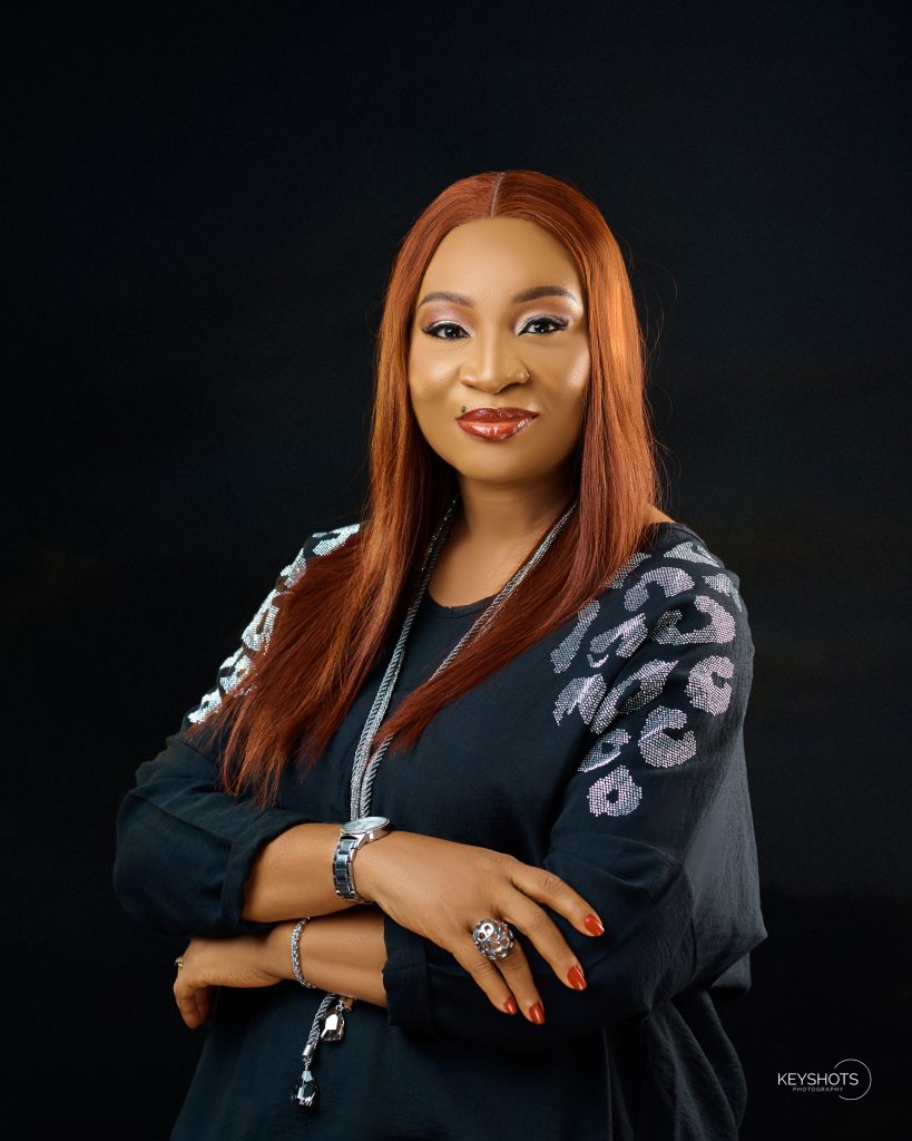 Uche Etiaba with folded arms in a black outfit